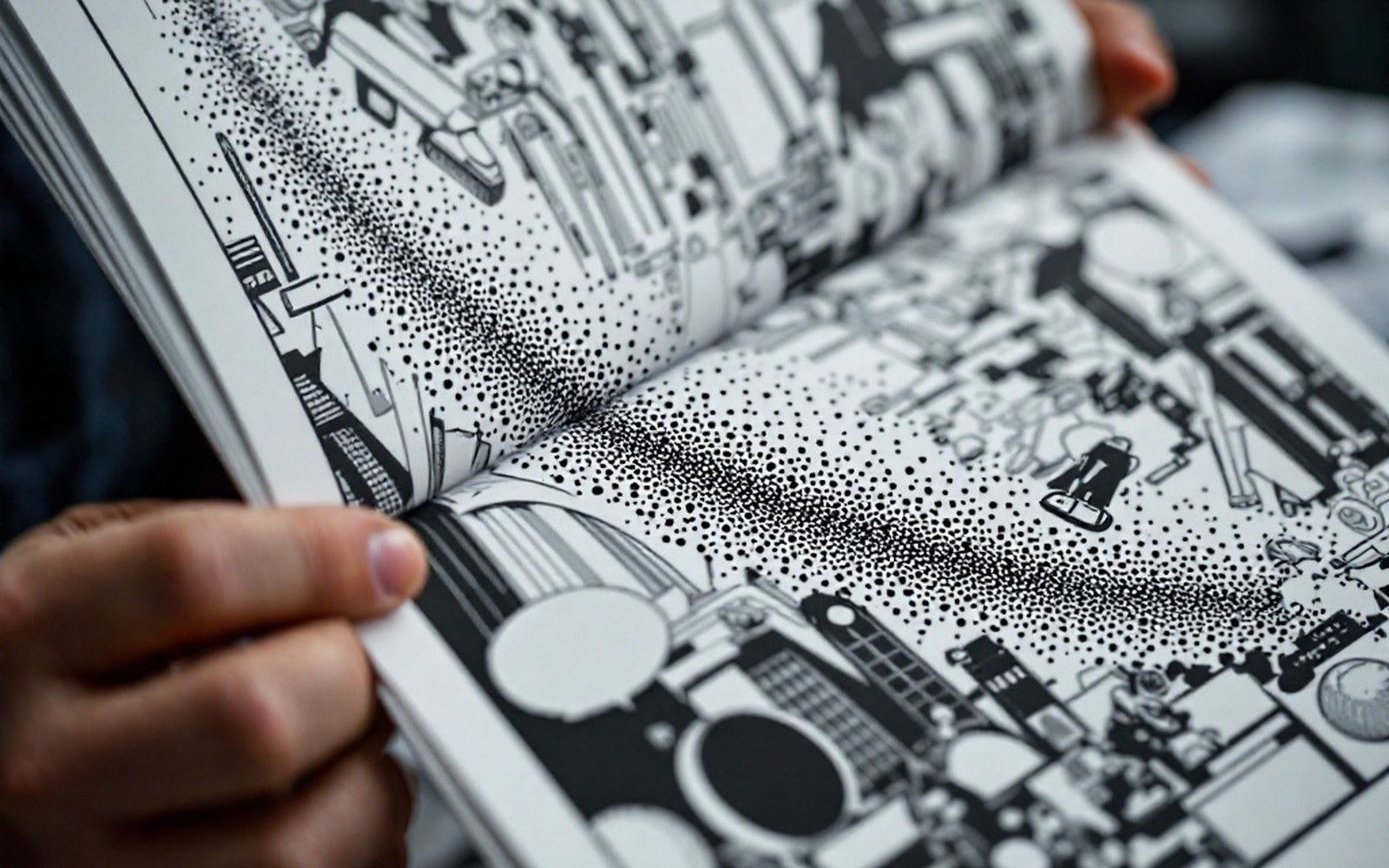 A printed comic page held at a steep angle so the halftone dot rosette is visible in the ink, close, hard light